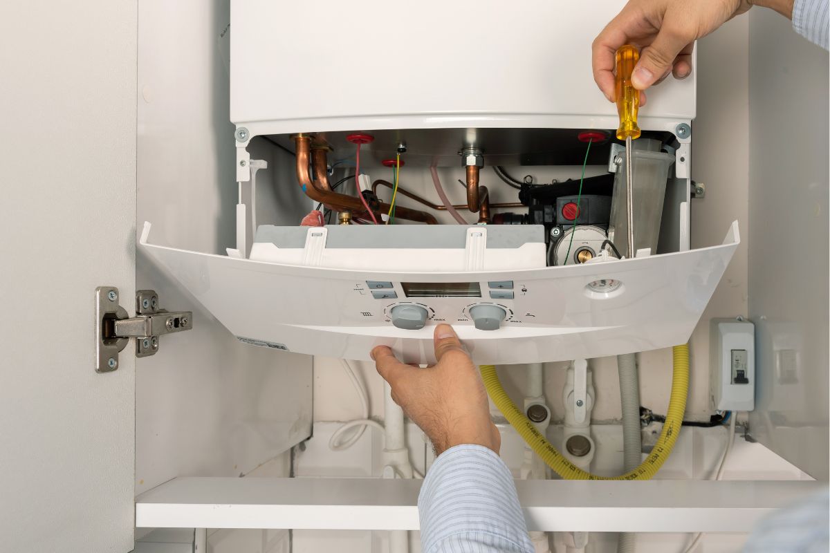 Technician repairing combi Gas Boiler